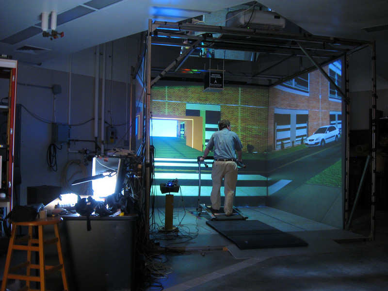 Man on treadmill inside an immersive project installation